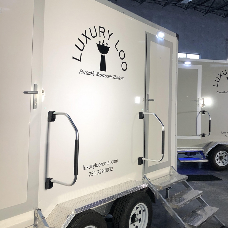 Image of Portable Restroom Rentals One, a slightly off white trailer.