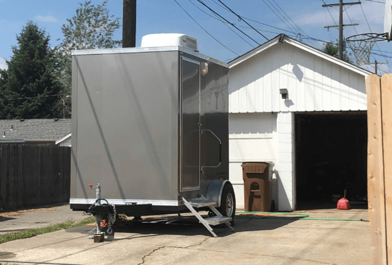 Portable Restroom Rental in front of a home.